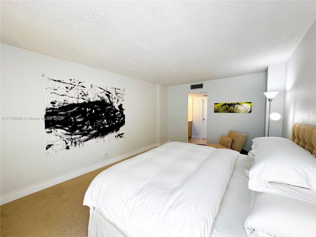 bedroom featuring light colored carpet and a textured ceiling