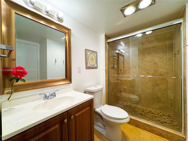 bathroom with vanity, toilet, and an enclosed shower