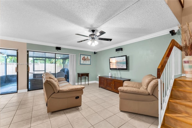 tiled living room featuring a textured ceiling, ornamental molding, and ceiling fan