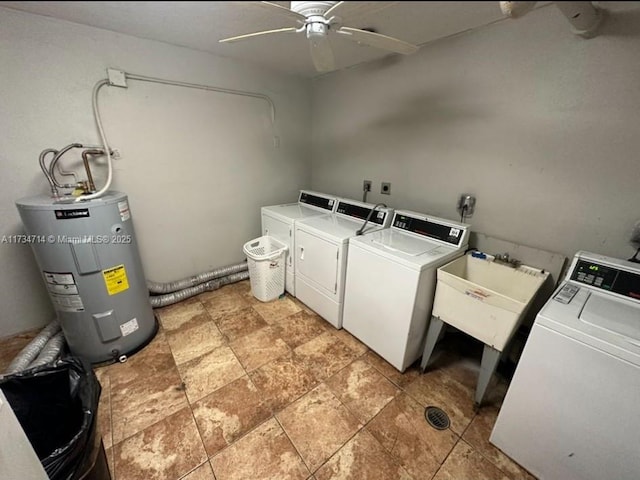 clothes washing area featuring electric water heater, sink, independent washer and dryer, and ceiling fan