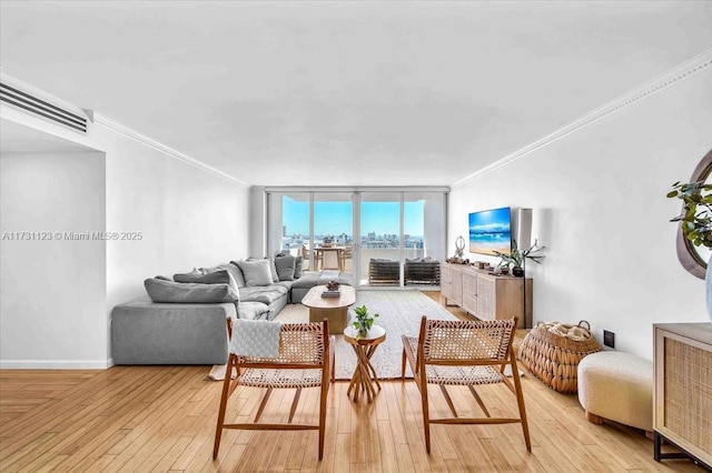 living room with expansive windows, ornamental molding, and light hardwood / wood-style floors