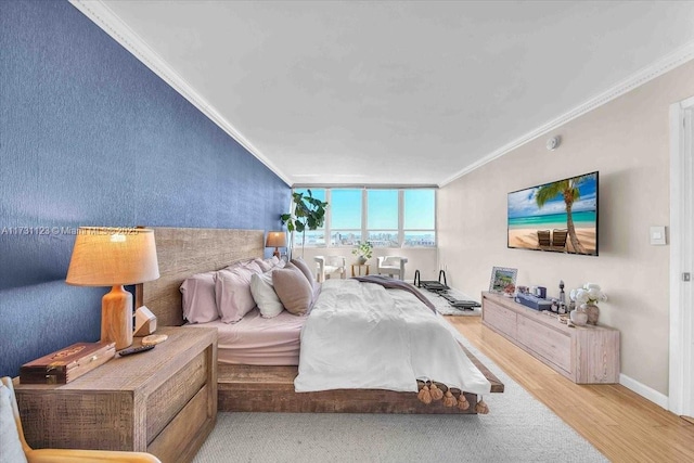 bedroom featuring hardwood / wood-style floors and crown molding