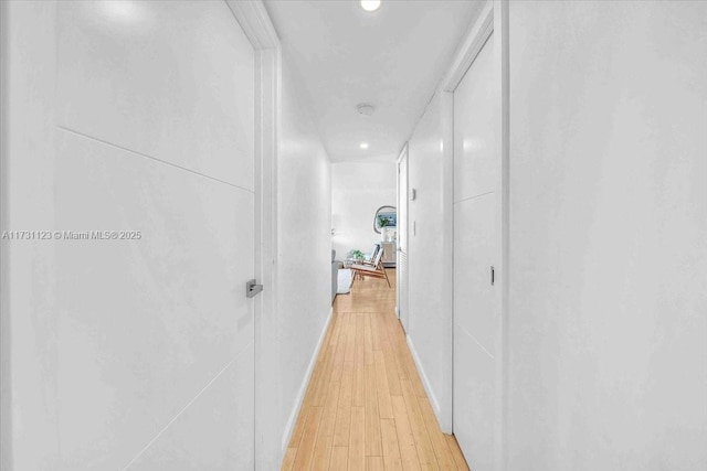 corridor with light wood-type flooring