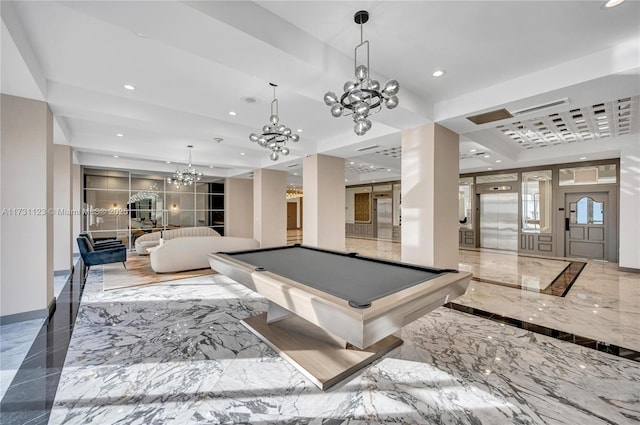 recreation room featuring a notable chandelier, a tray ceiling, pool table, and elevator