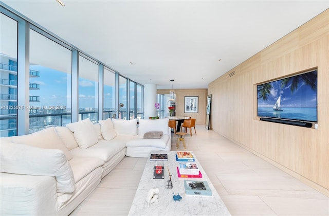 living room with wooden walls and a water view