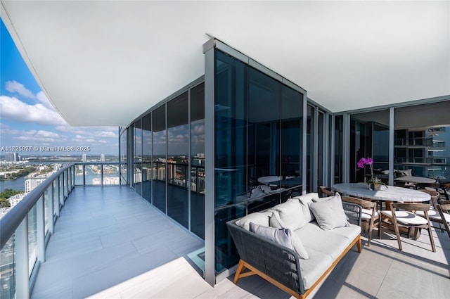 balcony with a water view and an outdoor living space