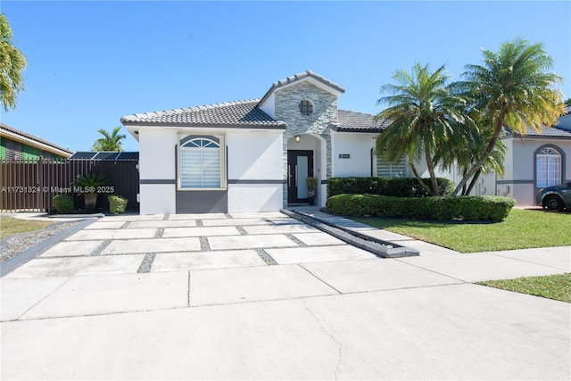 mediterranean / spanish house with a front lawn