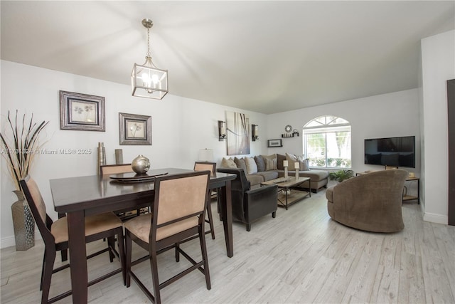 dining space featuring a chandelier and light wood-type flooring