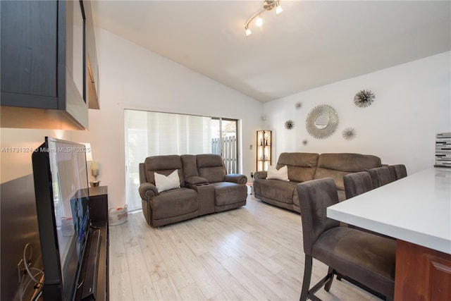 living room featuring high vaulted ceiling and light wood-type flooring