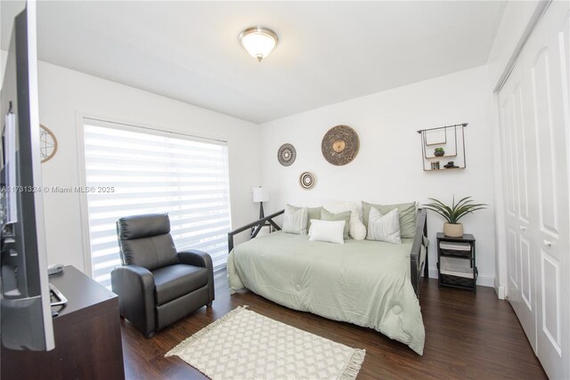 bedroom with lofted ceiling, wooden walls, dark hardwood / wood-style floors, and ceiling fan