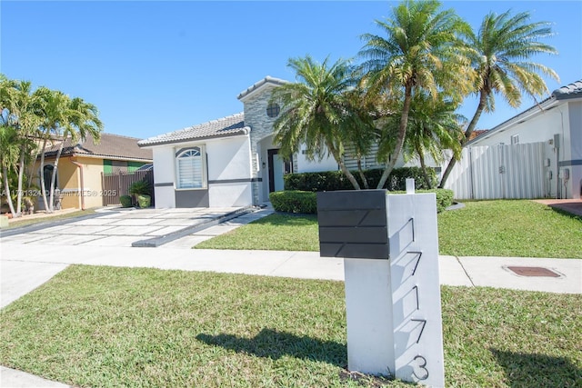 mediterranean / spanish-style home with a front yard