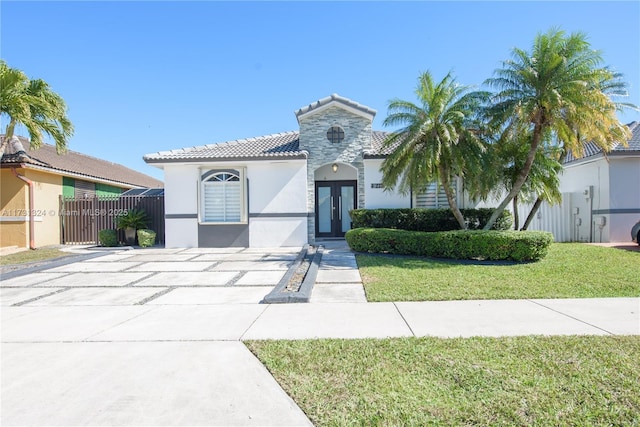 mediterranean / spanish-style house featuring a front yard