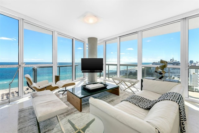 sunroom featuring a water view