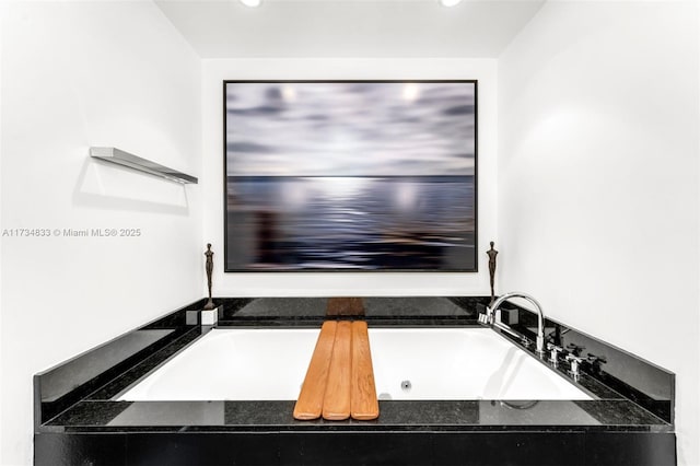 bathroom featuring tiled bath