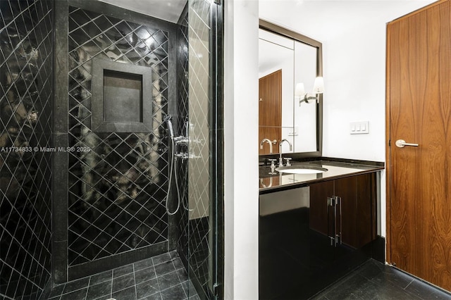 bathroom featuring tiled shower, vanity, and tile patterned floors