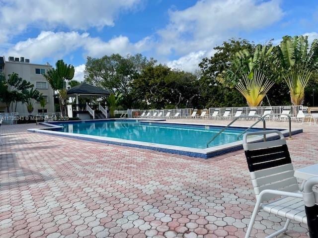 view of swimming pool with a gazebo and a patio