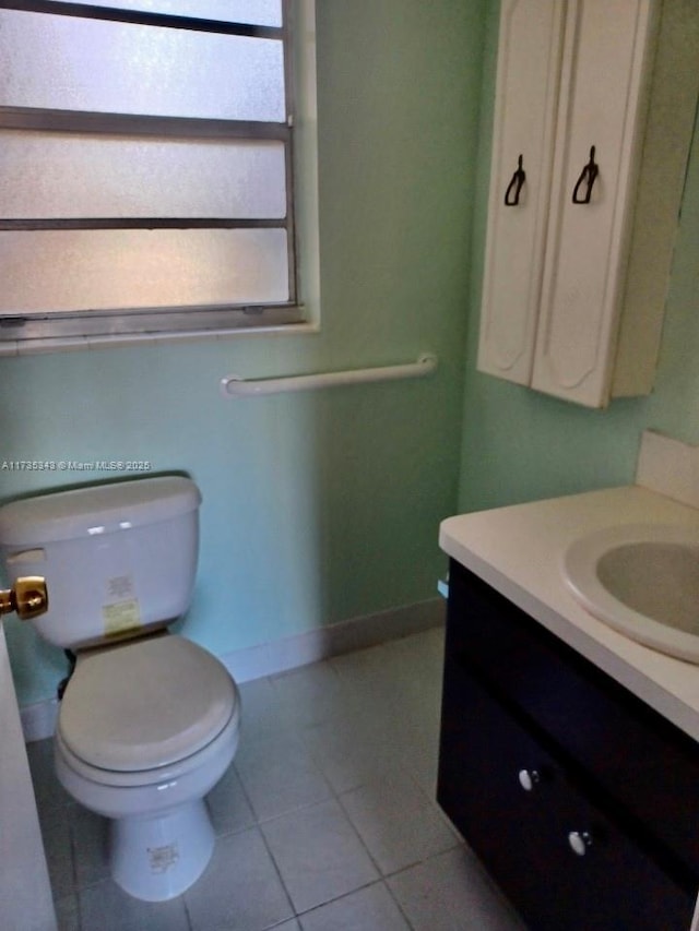 bathroom with tile patterned floors, toilet, and vanity