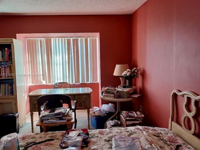 bedroom featuring carpet floors and a textured ceiling