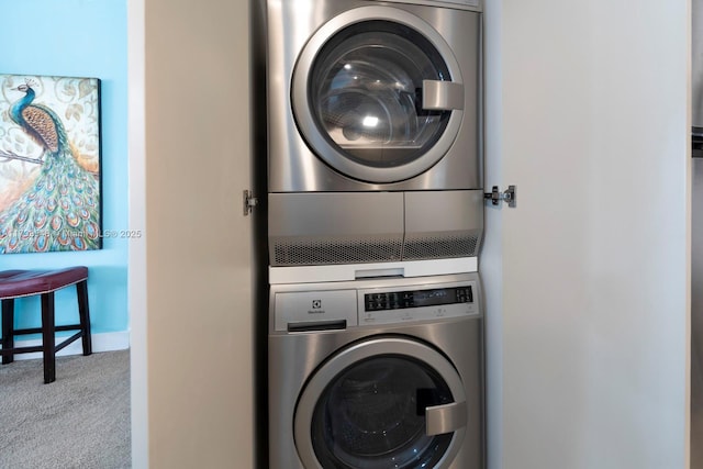 laundry room with stacked washer and dryer and light carpet