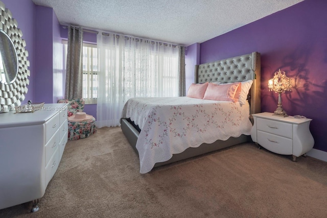 bedroom featuring light colored carpet and a textured ceiling