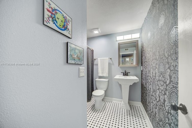 bathroom with walk in shower, toilet, and tile patterned flooring