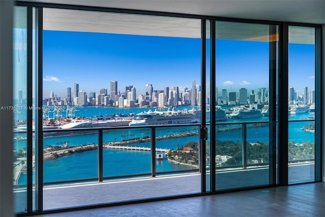 interior space featuring a water view, a healthy amount of sunlight, and floor to ceiling windows