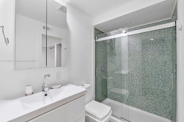 bathroom with vanity, toilet, and an enclosed shower