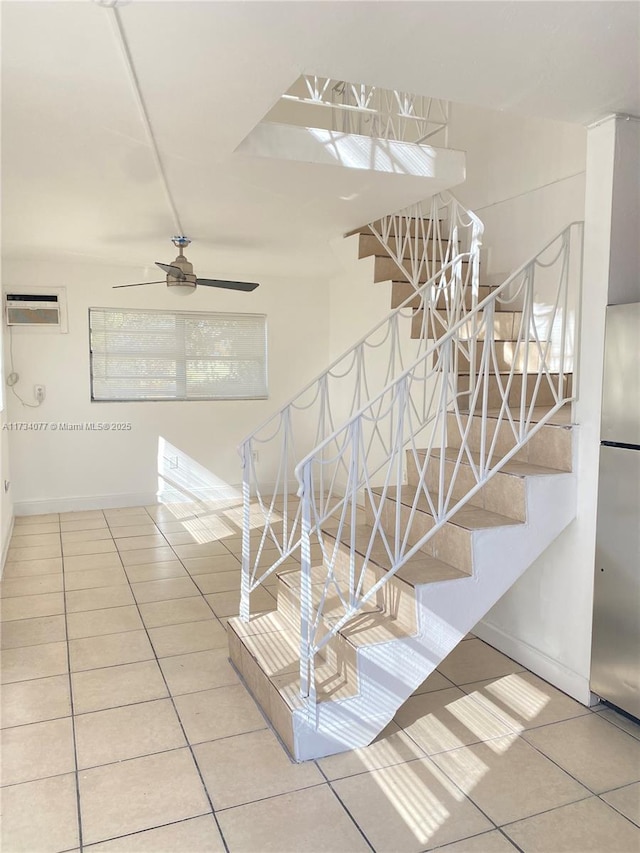 staircase featuring ceiling fan, tile patterned flooring, and an AC wall unit