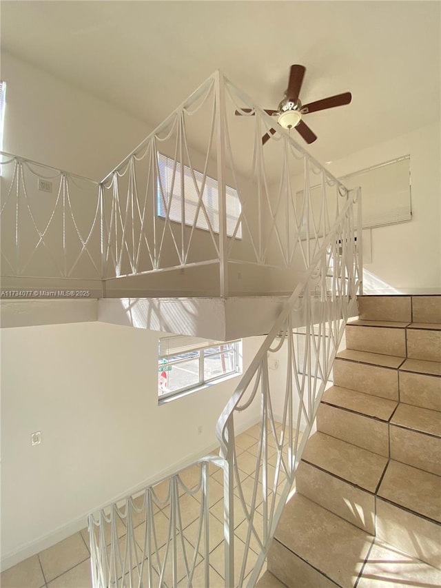 staircase with tile patterned floors and ceiling fan