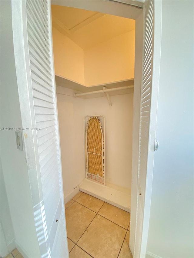 walk in closet with light tile patterned floors