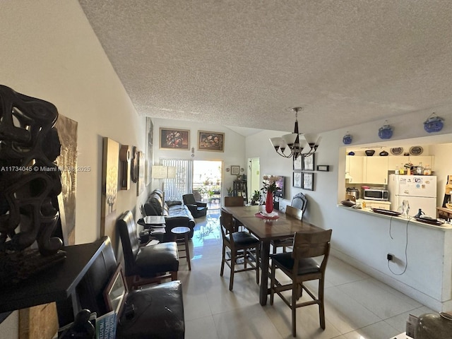 tiled dining area featuring a chandelier and a textured ceiling