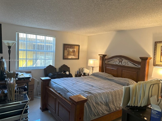 bedroom with a textured ceiling and light tile patterned flooring