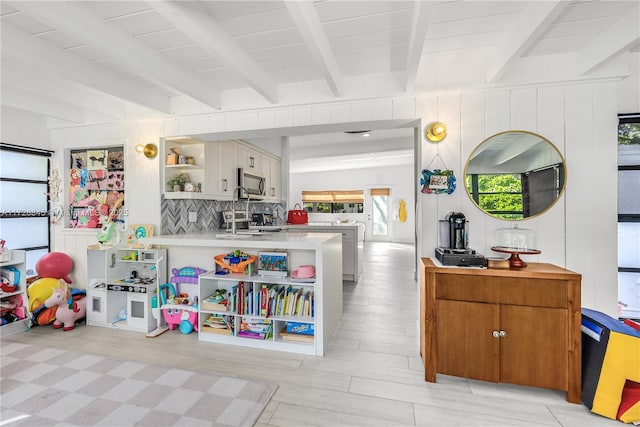 playroom with sink and beam ceiling