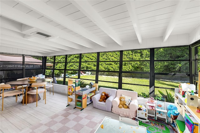 sunroom featuring beamed ceiling, a healthy amount of sunlight, and visible vents