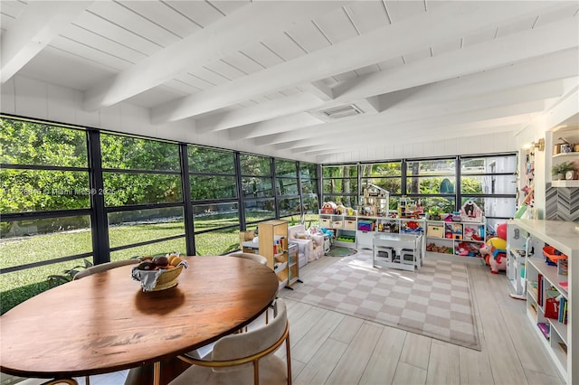 sunroom / solarium featuring beamed ceiling, wood ceiling, and a wealth of natural light