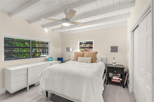 bedroom featuring wood ceiling, beam ceiling, light hardwood / wood-style floors, and ceiling fan