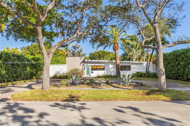 view of front of property with fence and stucco siding
