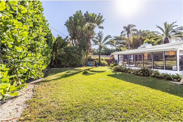 view of yard featuring a sunroom