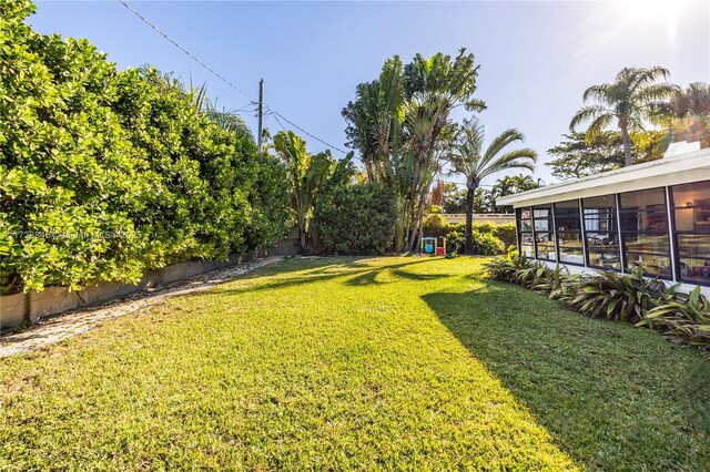 view of yard featuring a sunroom