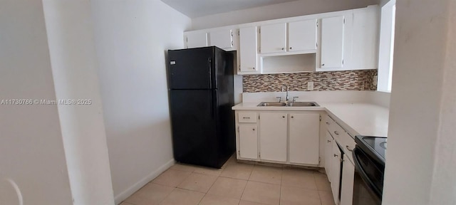 kitchen featuring light tile patterned floors, sink, white cabinetry, backsplash, and black appliances