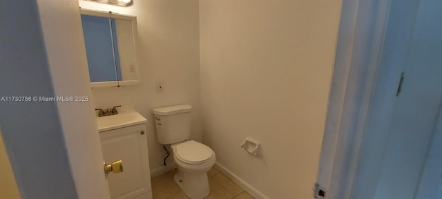 bathroom with vanity, tile patterned floors, and toilet