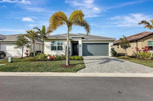 ranch-style house featuring a garage and a front yard