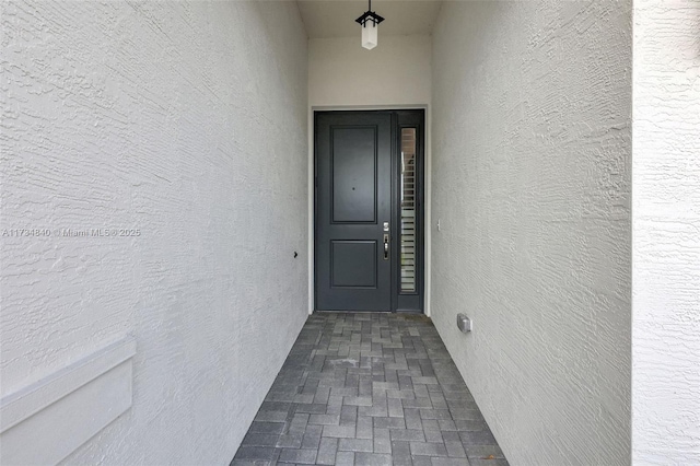 view of exterior entry with stucco siding