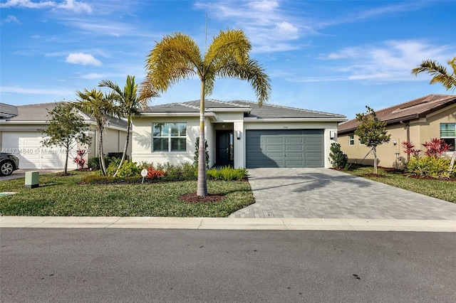 13597 SW Oceanus Blvd, Port St Lucie, FL 34987 - single story home featuring a garage, stucco siding, driveway, a tiled roof, and a front lawn