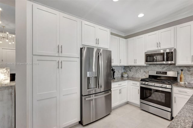 kitchen featuring appliances with stainless steel finishes, white cabinetry, stone counters, decorative backsplash, and recessed lighting