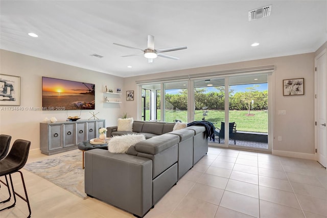 living room with a ceiling fan, recessed lighting, and baseboards
