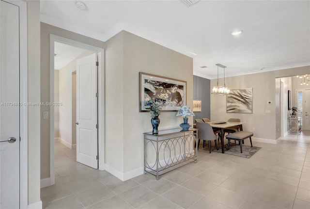 hall with a chandelier, light tile patterned floors, baseboards, crown molding, and recessed lighting