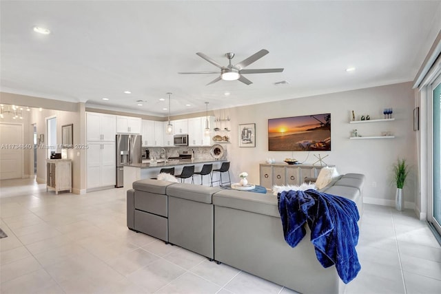 living area featuring a ceiling fan, recessed lighting, light tile patterned floors, ornamental molding, and baseboards