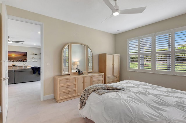 13597 SW Oceanus Blvd, Port St Lucie, FL 34987 - bedroom with light tile patterned floors, ceiling fan, and baseboards