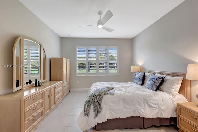 bedroom featuring light tile patterned flooring, baseboards, and ceiling fan